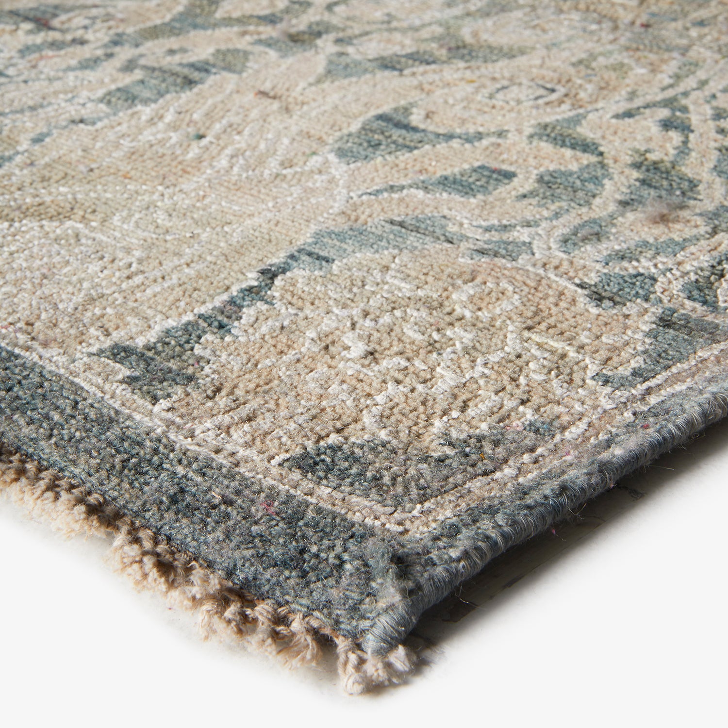 Close-up of a high-quality beige and blue patterned carpet.
