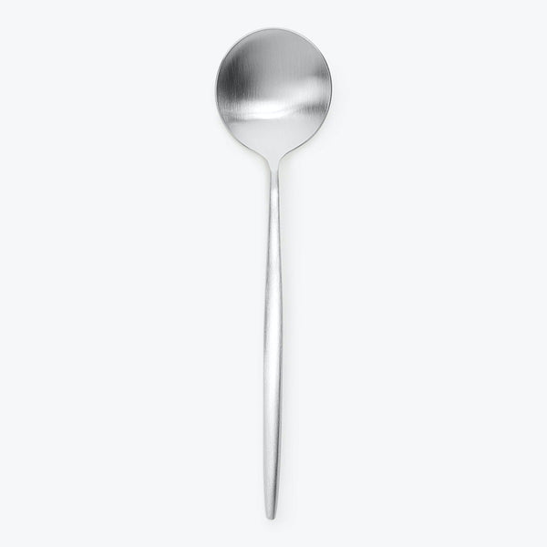Simple and sleek stainless steel spoon against white background.