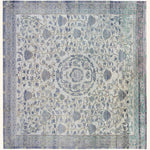 An intricately designed vintage rug with muted colors and symmetrical patterns.