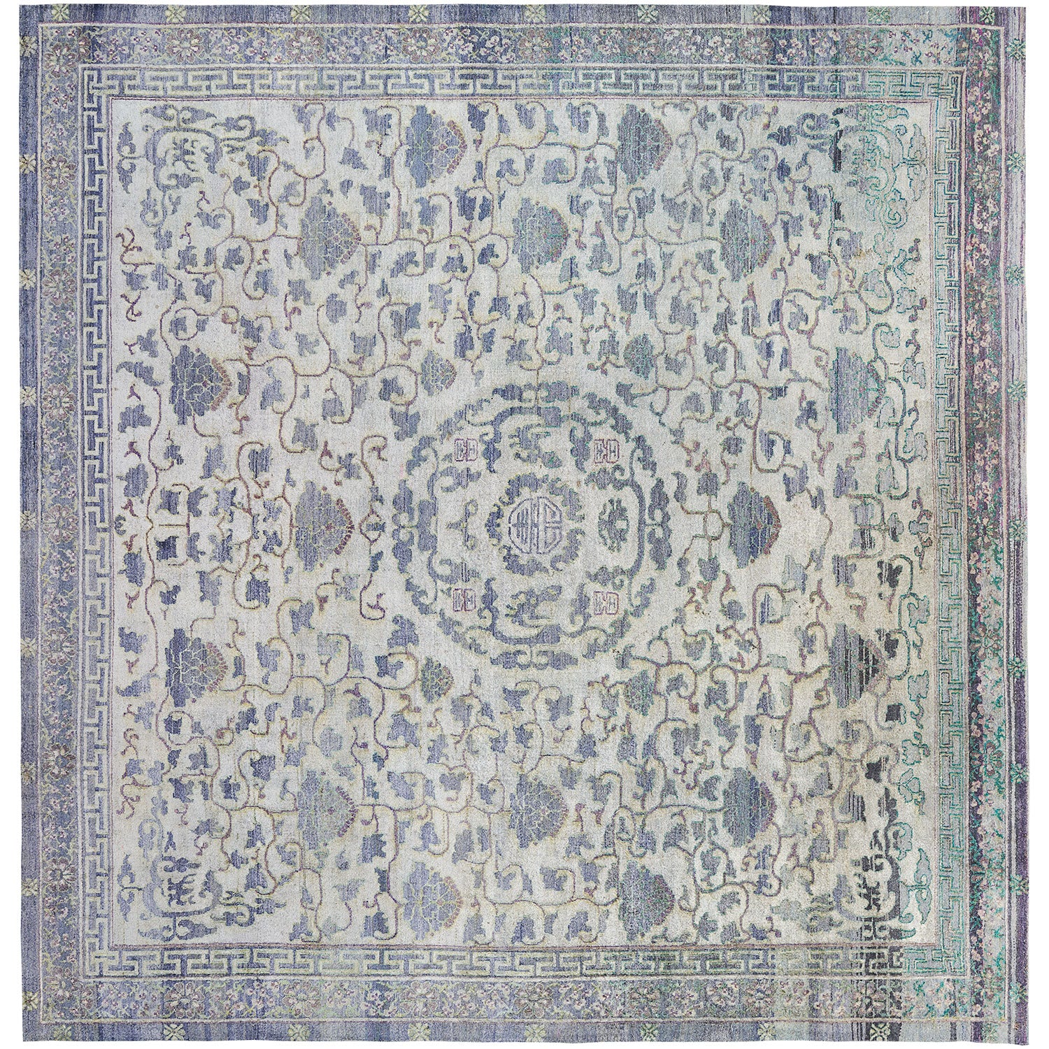 An intricately designed vintage rug with muted colors and symmetrical patterns.