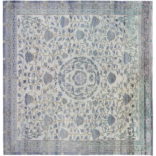 An intricately designed vintage rug with muted colors and symmetrical patterns.
