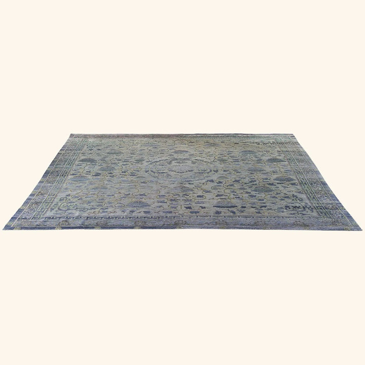 Traditional Persian-style rug featuring intricate patterns in muted blues and greys.
