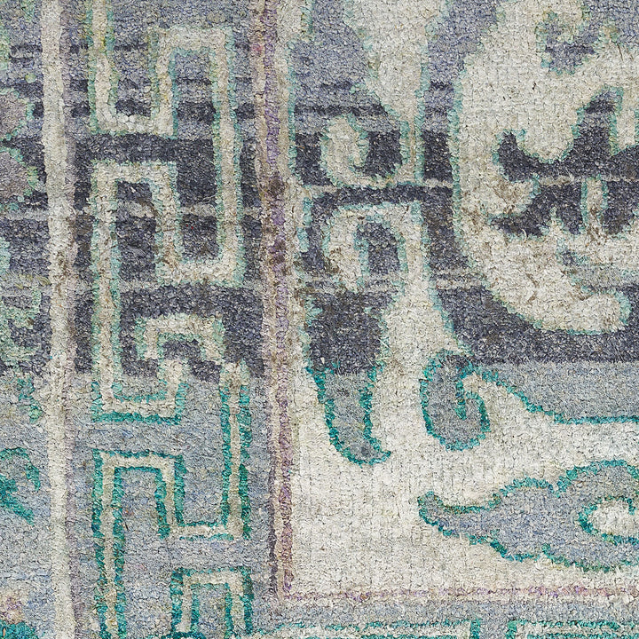 Intricate vintage textile with muted colors and varied pattern designs.