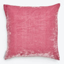 Square pink velvet pillow with slight shade variations, brand tag visible.