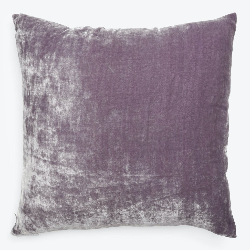 Square purple pillow with plush texture adds comfort and style.