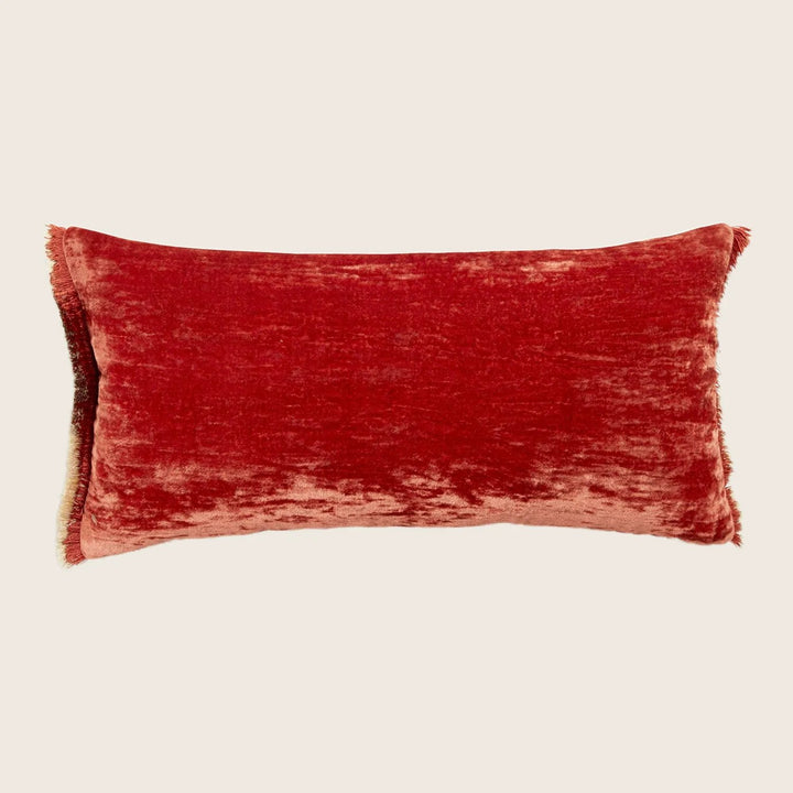 Luxurious red velvet-textured pillow adds a touch of comfort and style.