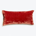 Luxurious red velvet-textured pillow adds a touch of comfort and style.