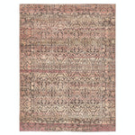 Intricate and symmetrical rug with ornate patterns in pink, cream, and charcoal.