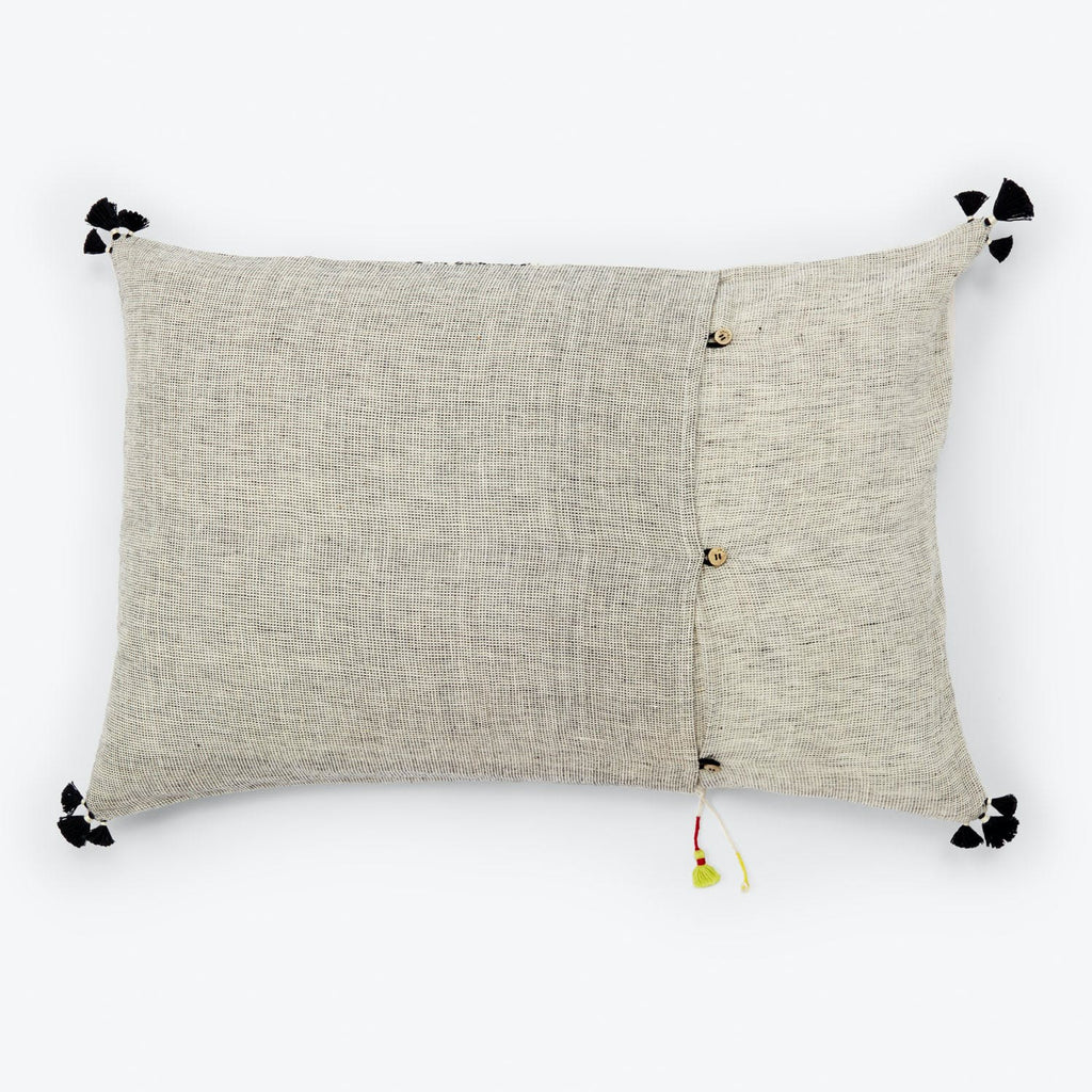 Rectangular decorative pillow in neutral tones with tassels and buttons.