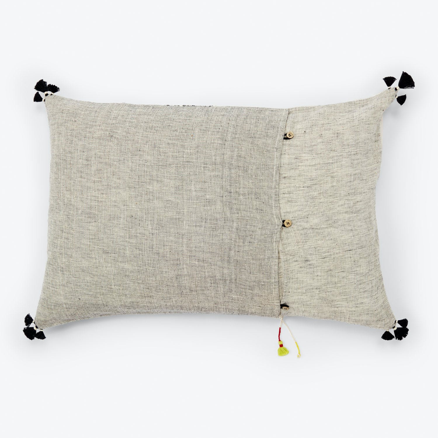 Rectangular decorative pillow in neutral tones with tassels and buttons.