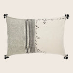 Rectangular decorative pillow with two-tone design and intricate patterns.