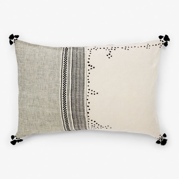 Rectangular decorative pillow with two-tone design and intricate patterns.
