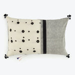 Decorative throw pillow with bohemian design and playful tassel accents.