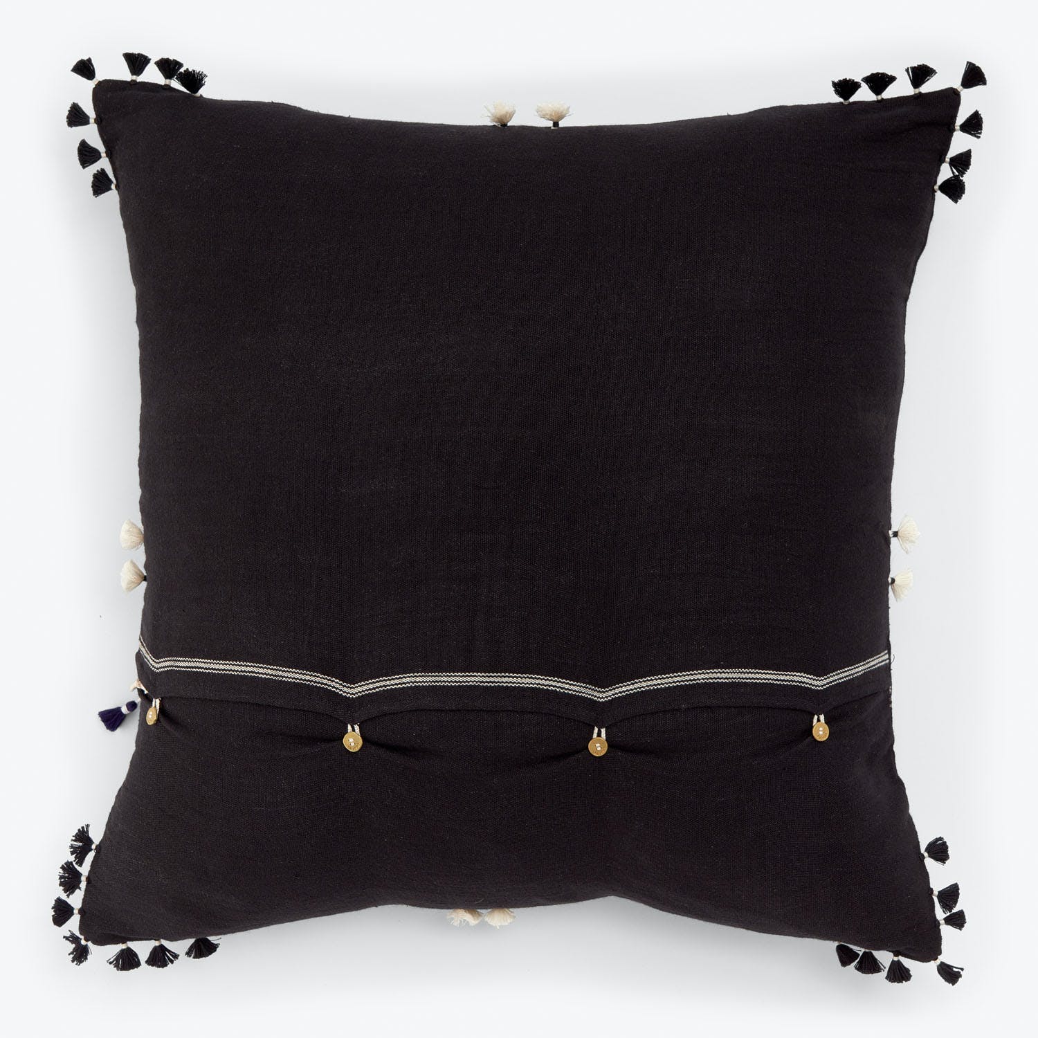 Square decorative pillow with black and off-white tassels and beads.