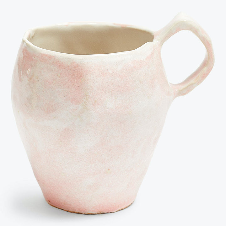 Handcrafted ceramic pitcher in light pink and white marbled design.