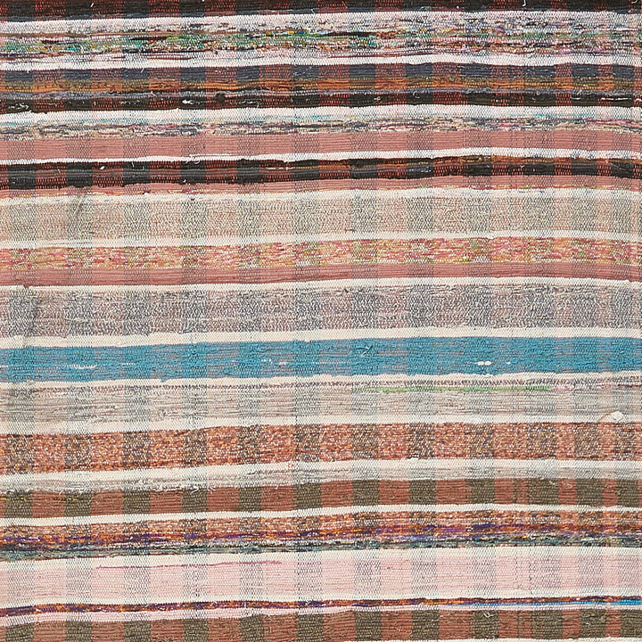 Colorful woven textile with diverse patterns and textures in horizontal stripes.