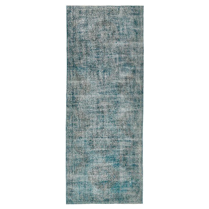 Vintage-style rectangular area rug in faded teal with abstract pattern