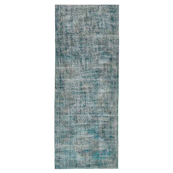 Vintage-style rectangular area rug in faded teal with abstract pattern