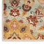 Intricately designed textile with floral motifs, possibly a vintage rug.