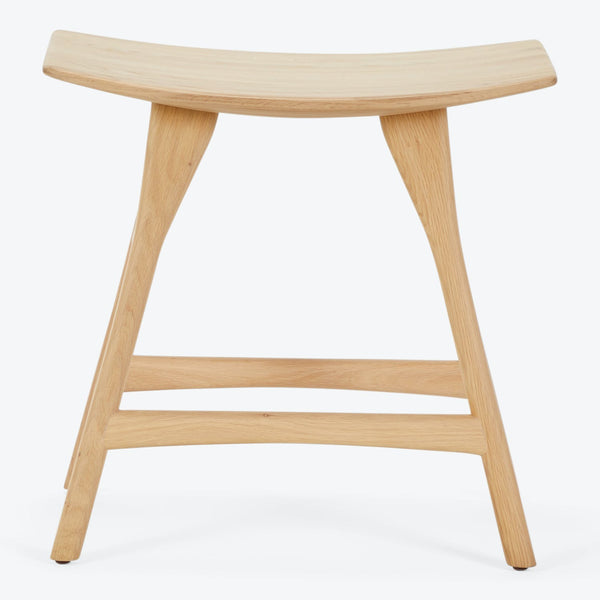Simple and modern wooden stool with ergonomic curved seat.