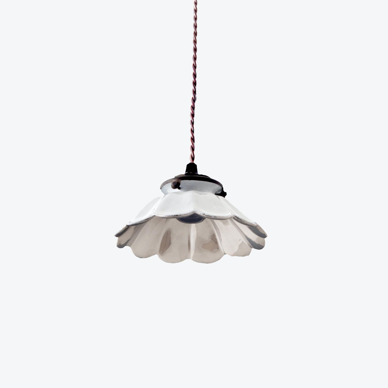 Floral-inspired pendant light with twisted fabric cable illuminates the room.