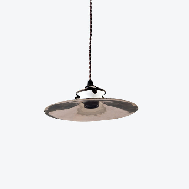 Industrial-style hanging light fixture with reflective silver interior and black exterior.