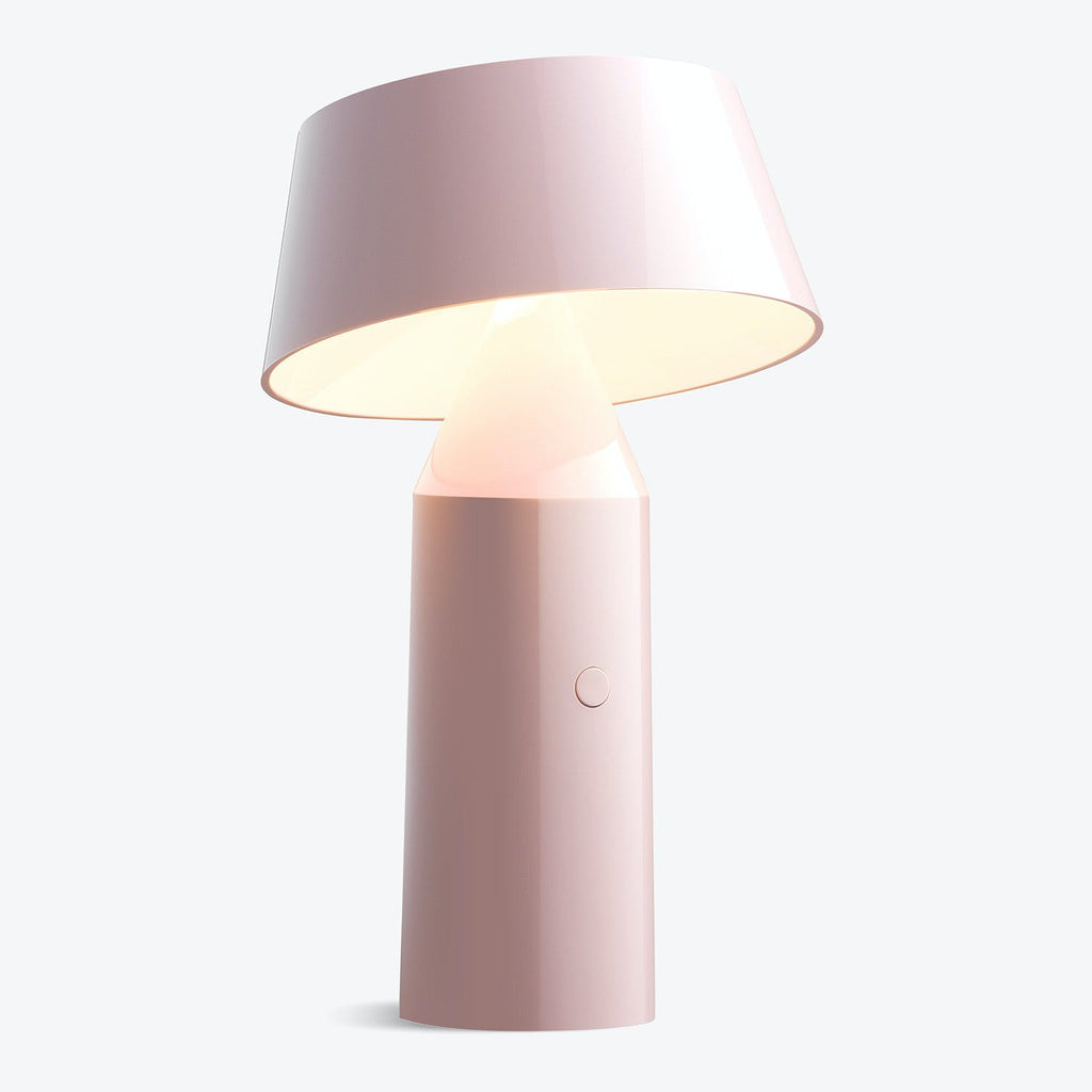 Modern and minimalist table lamp exuding a soft pink glow.