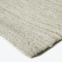 Close-up of textured fabric with natural color and mixed fibers.