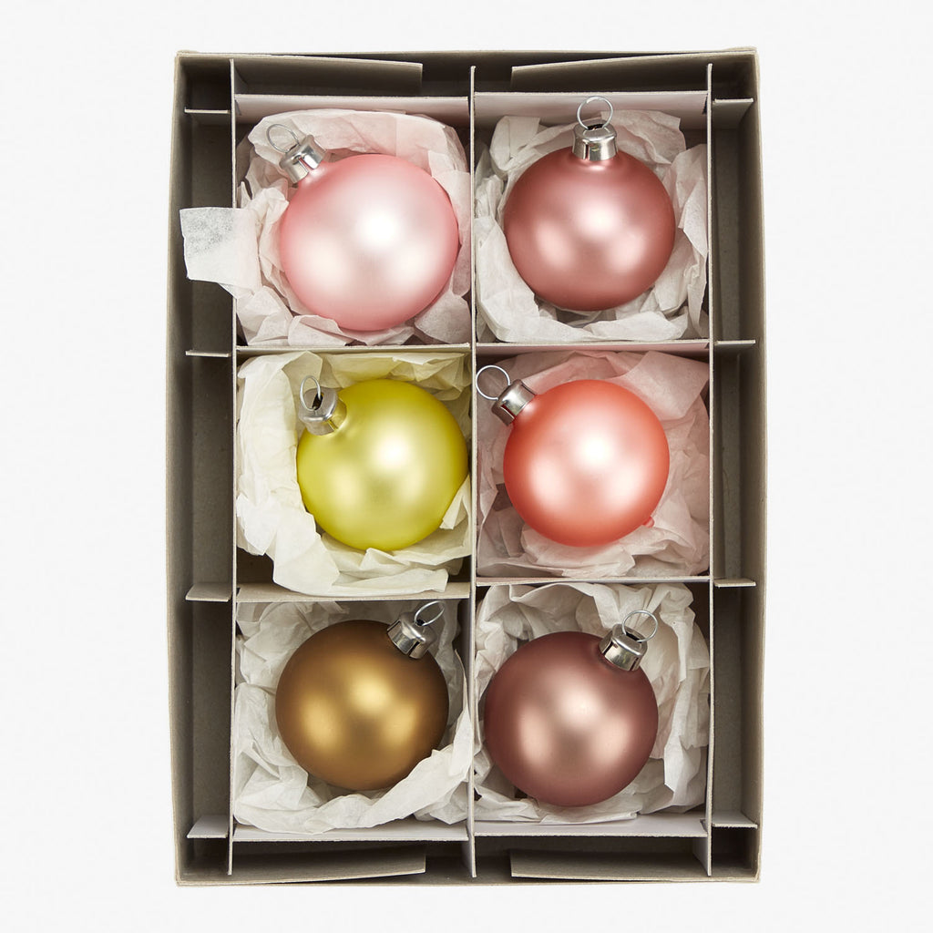 Cardboard storage box with compartments holding Christmas baubles ornaments.