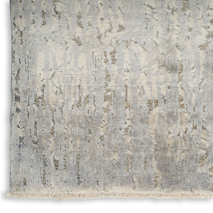 Modern distressed rug with abstract pattern and subtle beige accents.
