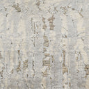 An aged surface with peeling paint in off-white and gray.