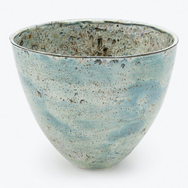 A rustic, hand-glazed ceramic bowl with a textured speckled finish.