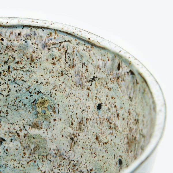 Close-up of a handcrafted ceramic bowl with a rustic glaze