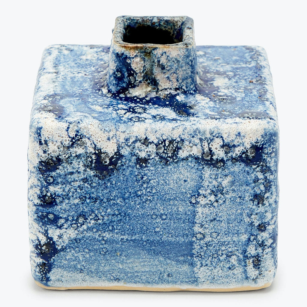 Ceramic inkwell with blue splatter glaze, showing signs of use.