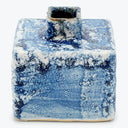 Ceramic inkwell with blue splatter glaze, showing signs of use.