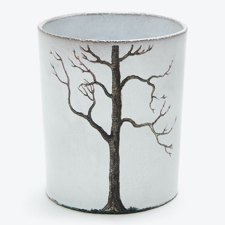Cylindrical object with a stylized tree painting, possibly representing winter.