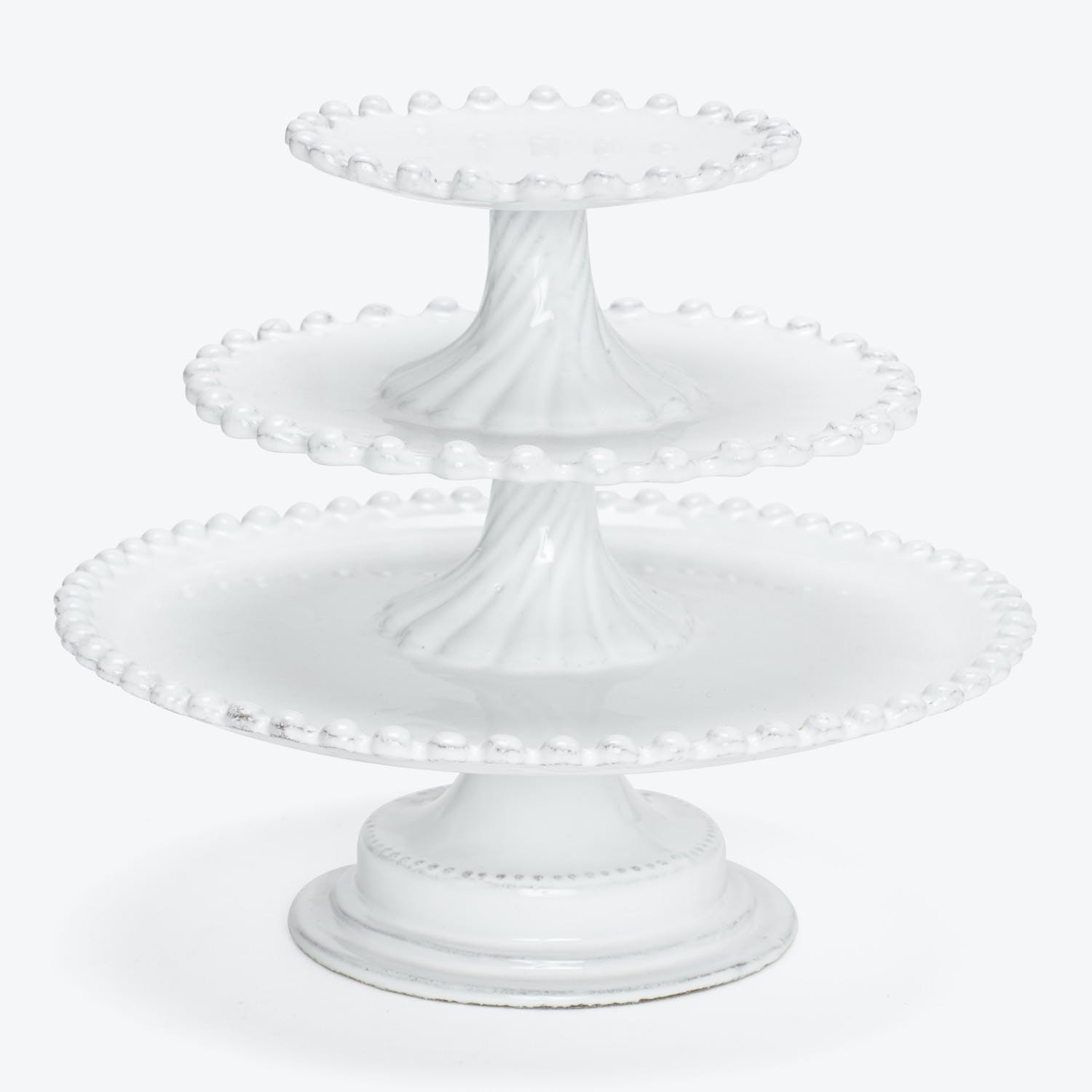 Elegant three-tiered white cake stand with decorative dotted edges.