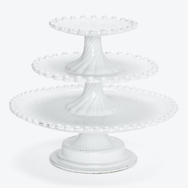 Elegant three-tiered white cake stand with decorative dotted edges.