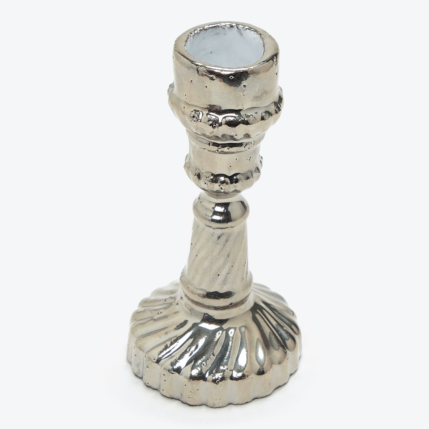 Vintage silver candlestick with intricate detailing and wax-catching holder.