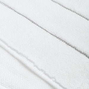 Neatly stacked white towels with embroidered stripes on white background. - hover