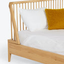 Modern wooden bed frame with mid-century design and cozy aesthetic.