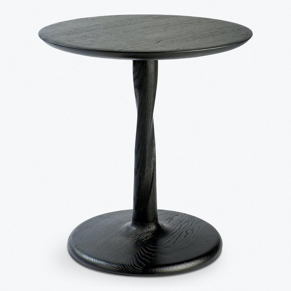 Modern round pedestal table with elegant dark finish and wood grain texture.