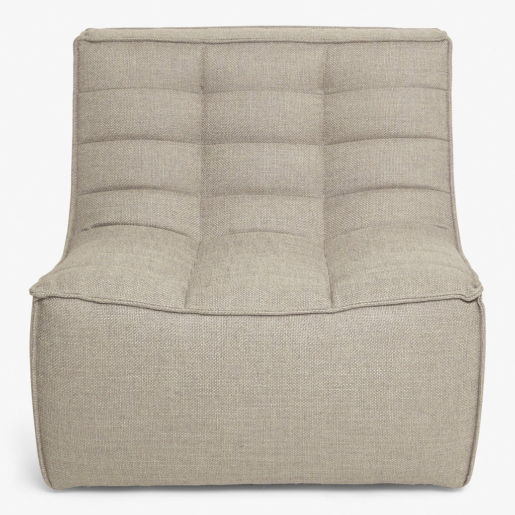 Contemporary fabric armchair featuring quilted backrest and plush seat.