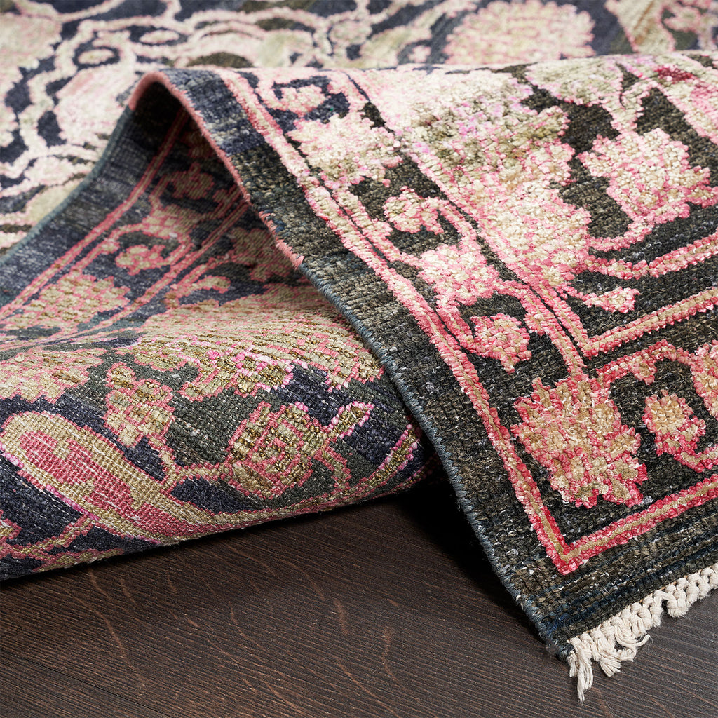 Close-up of an intricately patterned handwoven rug with vibrant colors