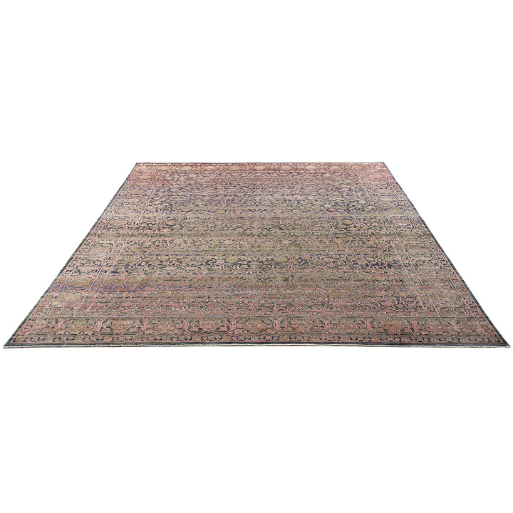 Vintage area rug with intricate floral patterns and muted colors.