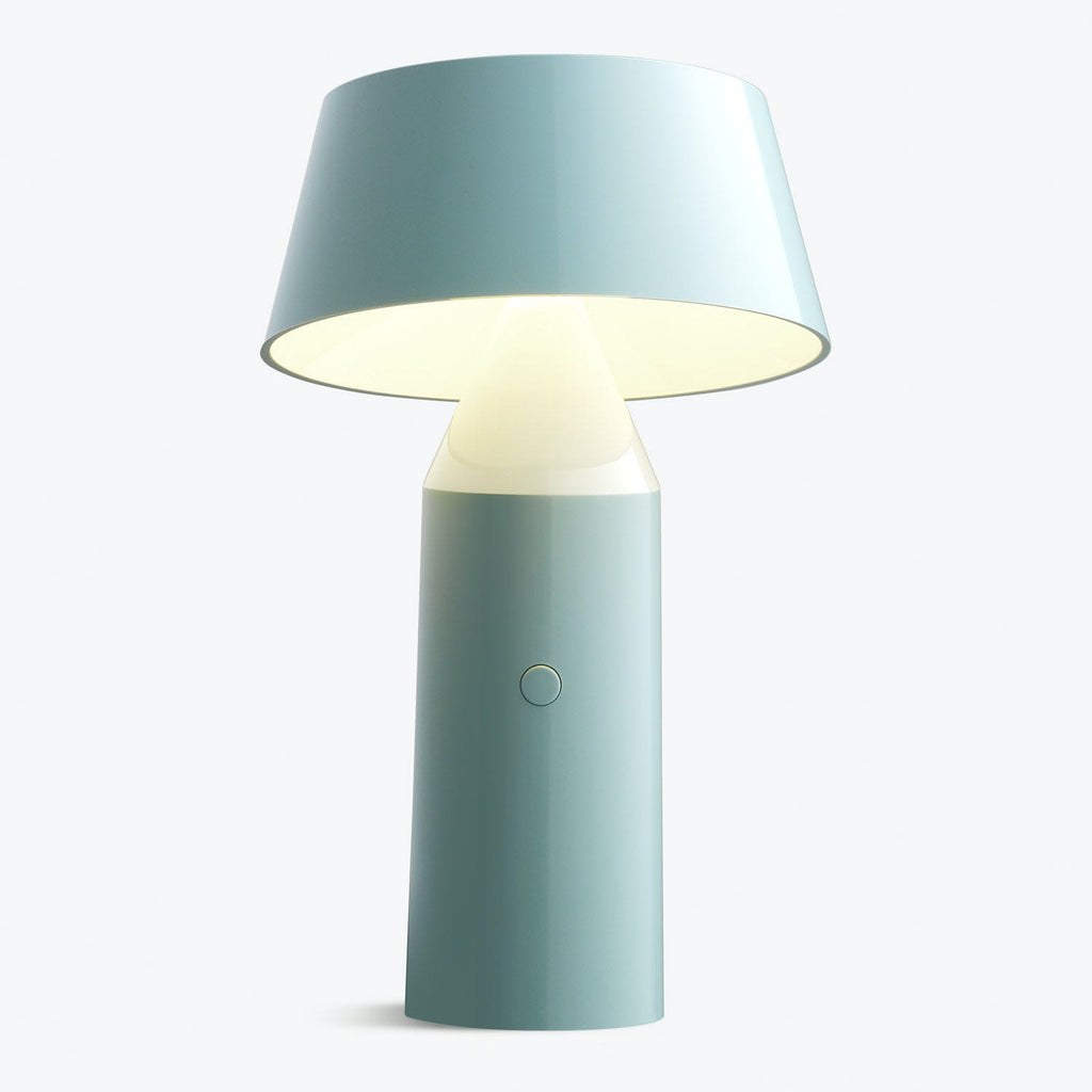 Modern table lamp in matte blue with warm LED lighting.