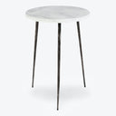 Contemporary round table with white marble top and black metal legs.