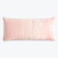 Rectangular pink pillow with textured brush stroke pattern against white background.