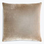 Soft, neutral-toned square cushion with a textured, velvet-like finish.