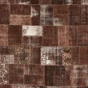 Textured, weathered fabric with assorted rectangles in earth tones.